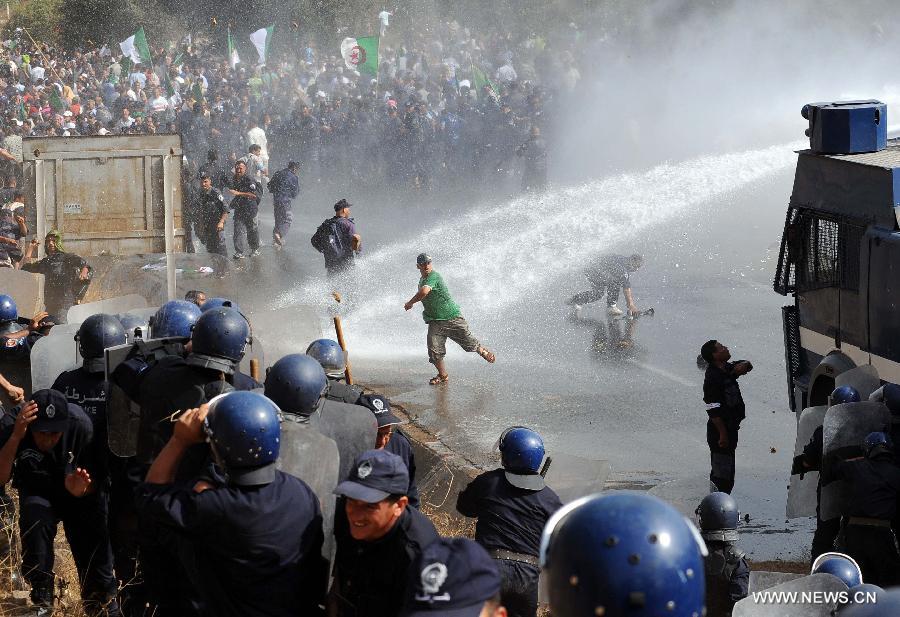 Riot police clash with community police during a demonstration in the neighbourhood of Bir Khadem in southern Algiers, capital of Algeria, on July 9, 2012. At least 5,000 members of the community police tried to go to the Presidency of the Republic to demand more socio-professional rights from the government. (Xinhua/Mohamed Kadri) 