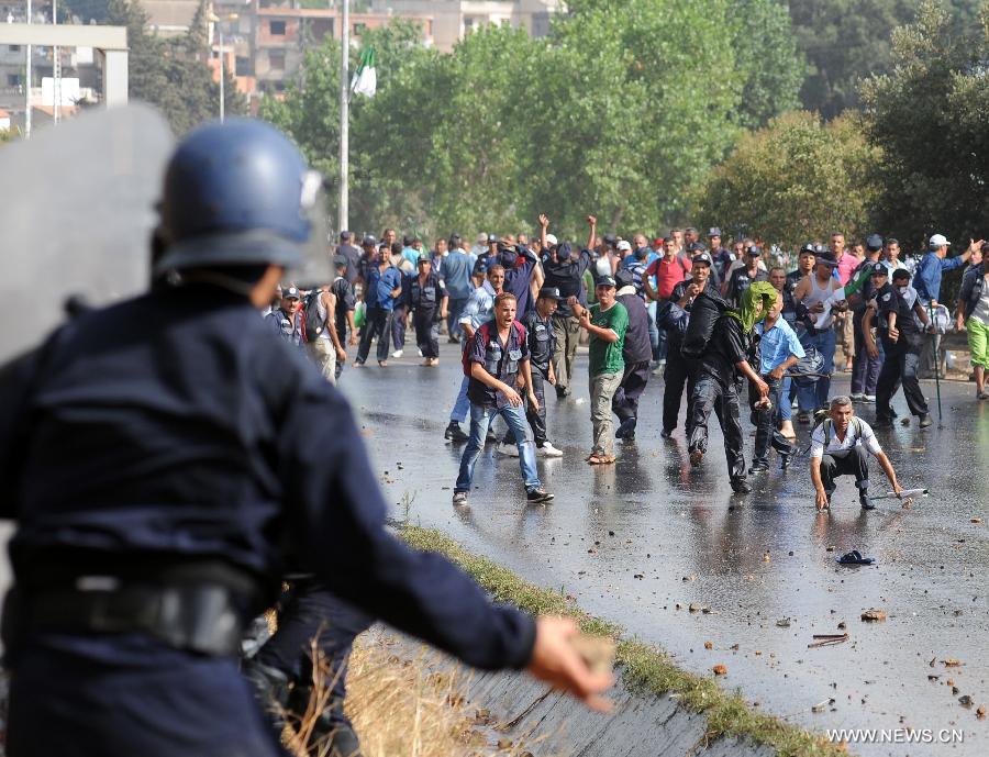 Riot police clash with community police during a demonstration in the neighbourhood of Bir Khadem in southern Algiers, capital of Algeria, on July 9, 2012. At least 5,000 members of the community police tried to go to the Presidency of the Republic to demand more socio-professional rights from the government. (Xinhua/Mohamed Kadri) 