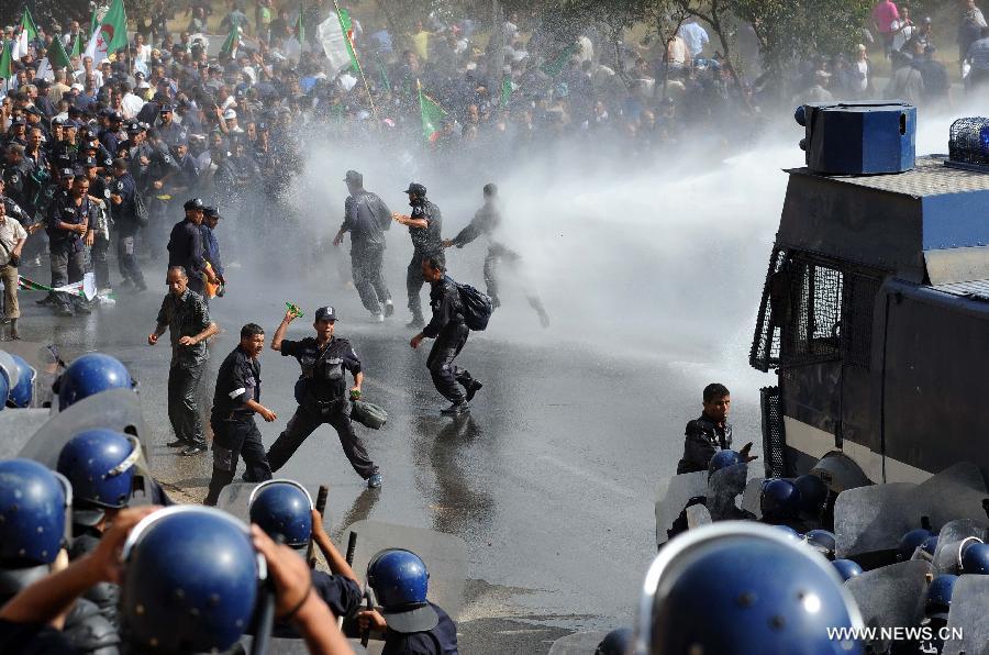 Riot police clash with community police during a demonstration in the neighbourhood of Bir Khadem in southern Algiers, capital of Algeria, on July 9, 2012. At least 5,000 members of the community police tried to go to the Presidency of the Republic to demand more socio-professional rights from the government. (Xinhua/Mohamed Kadri) 