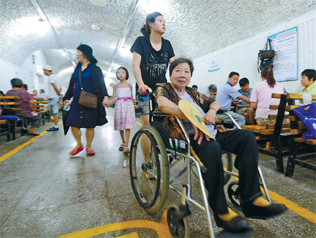 Residents enjoy the coolness in an air-raid shelter near Wushan Square in Hangzhou, Zhejiang province, on Monday. [China Daily] 