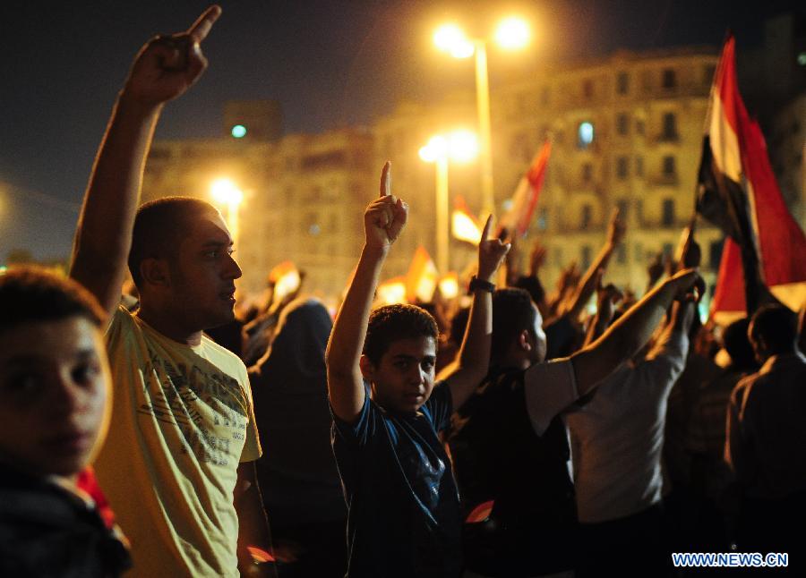 Egyptians participate in a rally to support the newly-elected Egypt's President Mohamed Morsi at Cairo's Tahrir Square in Egypt, July 10, 2012.