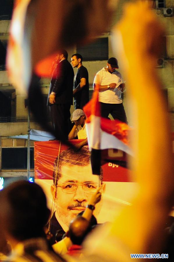 A picture of Egypt's President Mohamed Mursi is seen on a vehicle as his supporters gather at Cairo's Tahrir Square in Egypt, July 10, 2012.