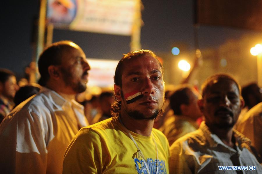 Egyptians participate in a rally to support the newly-elected Egypt's President Mohamed Morsi at Cairo's Tahrir Square in Egypt, July 10, 2012. 