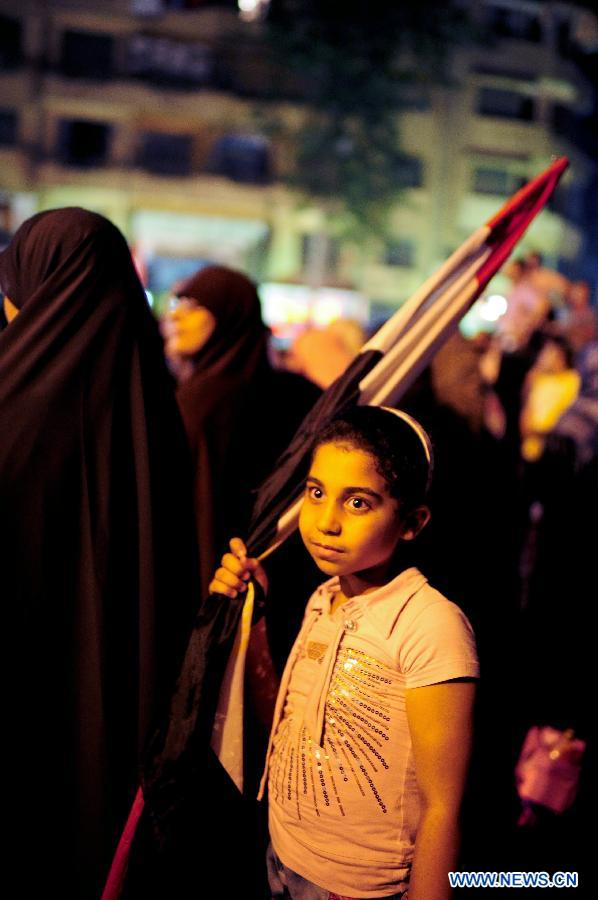 Egyptians participate in a rally to support the newly-elected Egypt's President Mohamed Morsi at Cairo's Tahrir Square in Egypt, July 10, 2012.