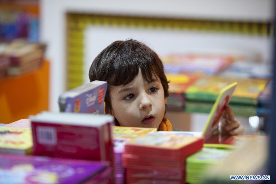 A child looks at books at the annual book fair for children in Buenos Aires, Argentina, July 10, 2012. (Xinhua/Martin Zabala) 