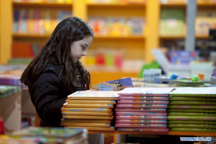 A girl reads a book at the annual book fair for children in Buenos Aires, Argentina, July 10, 2012. (Xinhua/Martin Zabala) 