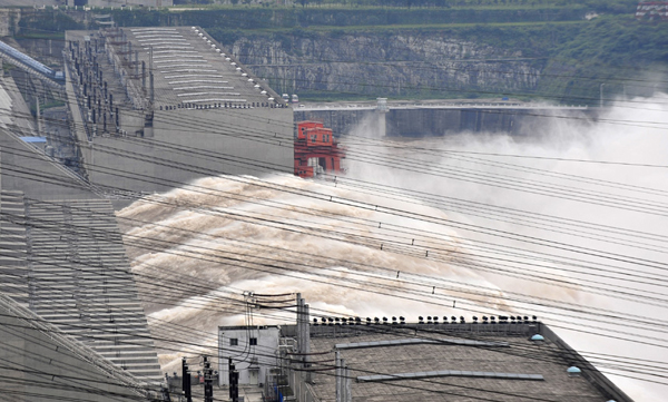Flood water pours out of sluices of the Three Gorges Dam in Yichang, Hubei Province, July 12, 2012. [Xinhua]