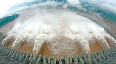 Water cascades from six sluices at Three Gorges Dam on Friday after a flood with a peak flow of 55,500 cubic meters per second on Thursday night significantly raised the water level in the dam's reservoir. [China Daily]