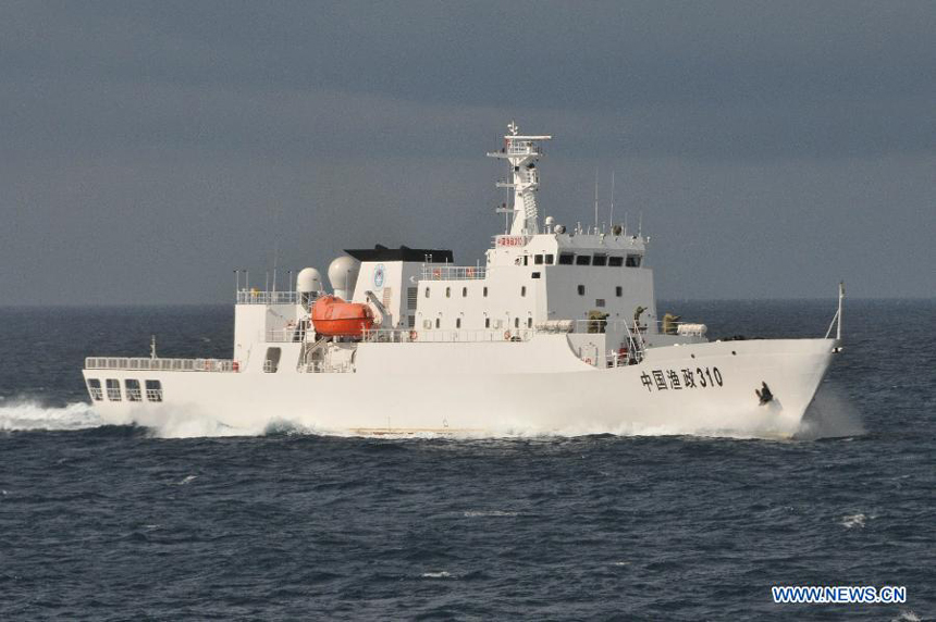 A fishery administration ship sails to Yongshu Reef of Nansha Islands to assist a fleet of fishing vessel, south China Sea, July 15, 2012. A fleet of 30 fishing vessels arrive at Yongshu Reef of south China Sea on Sunday. The fleet, departing from Sanya City of south China's Hainan Province on July 12, 2012, will spend 20 days fishing near the Yongshu Reef, sailors of the fleet said. 