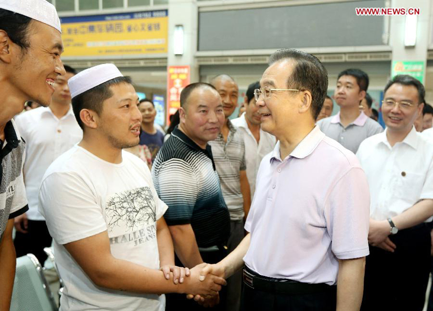 Chinese Premier Wen Jiabao (R, front) talks to truck drivers at a logistics hub in Chengdu, capital of southwest China's Sichuan Province, July 14, 2012. Wen Jiabao made an inspection tour of Sichuan Province from July 13 to 15. 