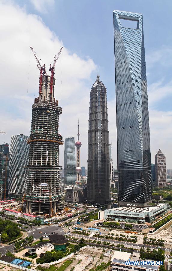 Photo taken on July 15, 2012 shows the Shanghai Tower under construction in the Pudong District of east China's Shanghai. The Shanghai Tower, to be the tallest building in Shanghai upon completion, started to be installed with curtain walls in recent days.