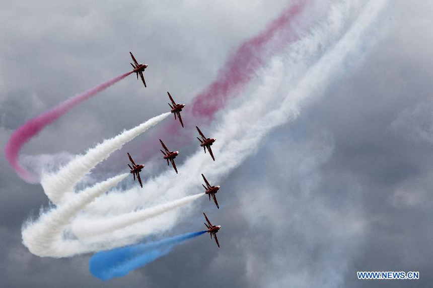 The Royal Air Force (RAF) Red Arrows perform during the Farnborough International Air Show in Hampshire, Britain, July 15, 2012. The air show was concluded on Sunday.