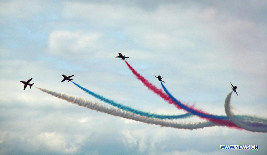 The Royal Air Force (RAF) Red Arrows perform during the Farnborough International Air Show in Hampshire, Britain, July 15, 2012. The air show was concluded on Sunday.