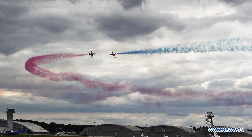 The Royal Air Force (RAF) Red Arrows perform during the Farnborough International Air Show in Hampshire, Britain, July 15, 2012. The air show was concluded on Sunday.