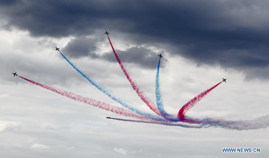 The Royal Air Force (RAF) Red Arrows perform during the Farnborough International Air Show in Hampshire, Britain, July 15, 2012. The air show was concluded on Sunday.