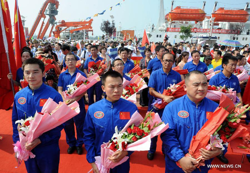 Three oceanauts of China's manned submersible, Jiaolong, attend a welcoming ceremony in Qingdao, east China's Shandong Province, July 16, 2012. China's manned submersible Jiaolong has successfully completed its program of deep sea dives, with a sixth and final dive to 7,000 meters in the Mariana Trench in the Pacific Ocean on June 30.