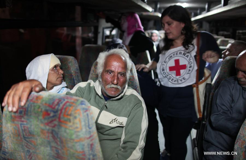 Relatives of Palestinian prisoners wait at a Red Cross's bus to visit Israeli prisons in Gaza City, on July 16, 2012. Israeli Prison service allowed families of 25 Gaza prisoners to visit them for the first time since 2007 after the capture of Israeli soldier Gilad Shalit by Hamas fighters, who was held in Gaza until last fall.