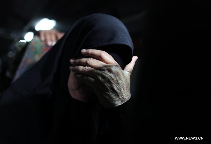 A mother of Palestinian prisoner weeps as she waits at a Red Cross's bus to visit Israeli prisons in Gaza City, on July 16, 2012. Israeli Prison service allowed families of 25 Gaza prisoners to visit them for the first time since 2007 after the capture of Israeli soldier Gilad Shalit by Hamas fighters, who was held in Gaza until last fall. 