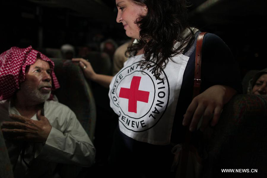 A Red Cross employee supervises the visiting of Palestinian prisoners' families at a Red Cross's bus to visit Israeli prisons in Gaza City, on July 16, 2012. Israeli Prison service allowed families of 25 Gaza prisoners to visit them for the first time since 2007 after the capture of Israeli soldier Gilad Shalit by Hamas fighters, who was held in Gaza until last fall. 