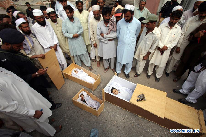 Pakistani people attend a funeral procession of three children, killed after a mortar bomb in a house, in northwest Pakistan's Peshawar on July 15, 2012. A mortar bomb smashed through a house at a village in northwestern Pakistan early Sunday, killing three children and their mother and injuring their father, police said.