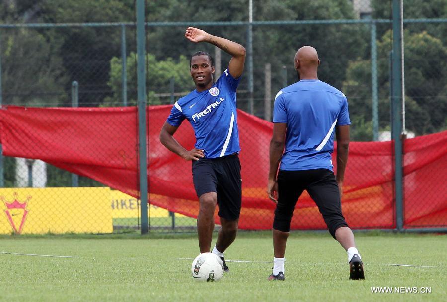 Shanghai Shenhua player Didier Drogba (L) trains for the first time with the team in Shanghai, China, July 16, 2012. Drogba signed a two-a-half-year contract with Shanghai Shenhua FC, which is expected to make him one of football's highest-paid players.(Xinhua/FanJun) 