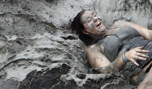 A tourist plays with mud during the opening day of the Boryeong Mud Festival at Daecheon beach in Boryeong, about 190 km (118 miles) southwest of Seoul.