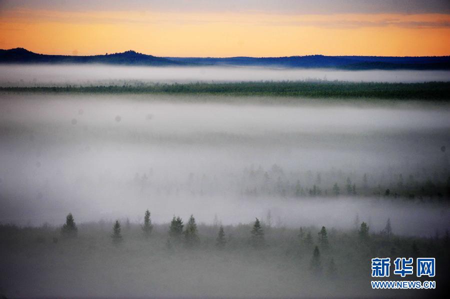 Photo taken on July 13, 2012 shows the scenery of Wuyiling wetlands enveloped in a morning fog in Yichun, northeast China's Heilongjiang Province. The Wuyiling Wetlands Natural Reserve has the highest wetlands in Lesser Khingan and the largest permafrost islets, containing a rich diversity of flora and fauna. [Xinhua]