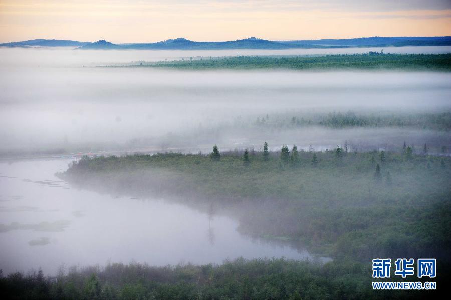 Photo taken on July 13, 2012 shows the scenery of Wuyiling wetlands enveloped in a morning fog in Yichun, northeast China's Heilongjiang Province. The Wuyiling Wetlands Natural Reserve has the highest wetlands in Lesser Khingan and the largest permafrost islets, containing a rich diversity of flora and fauna. [Xinhua]