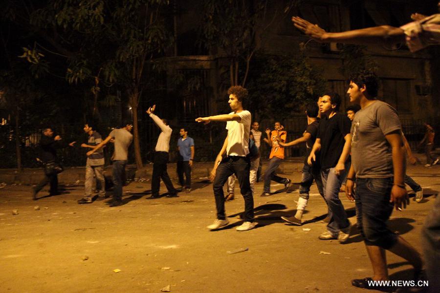 Egyptian protesters clash with riot police after a protest demanding expulsion of the Syrian ambassador near the Syrian embassy in Cairo, Egypt on July 18, 2012. Dozens of protesters were wounded and at least 14 police soldiers were injured during the clashes. (Xinhua/Amru Salahuddien) 