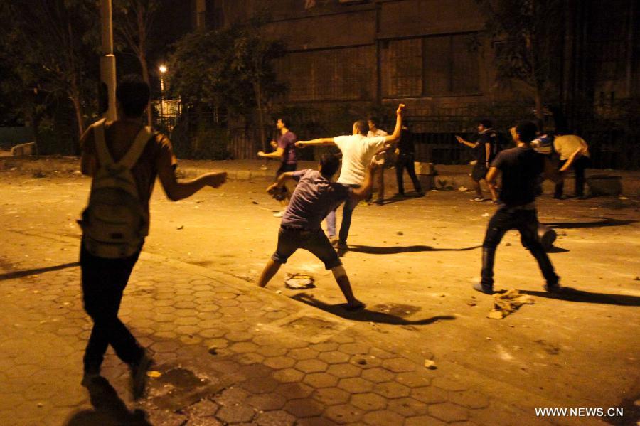 Egyptian protesters clash with riot police after a protest demanding expulsion of the Syrian ambassador near the Syrian embassy in Cairo, Egypt on July 18, 2012. Dozens of protesters were wounded and at least 14 police soldiers were injured during the clashes. (Xinhua/Amru Salahuddien) 