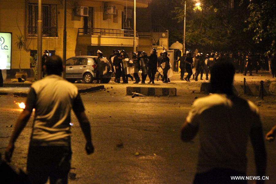 Egyptian protesters clash with riot police after a protest demanding expulsion of the Syrian ambassador near the Syrian embassy in Cairo, Egypt on July 18, 2012. Dozens of protesters were wounded and at least 14 police soldiers were injured during the clashes. (Xinhua/Amru Salahuddien) 