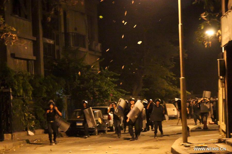 Egyptian protesters clash with riot police after a protest demanding expulsion of the Syrian ambassador near the Syrian embassy in Cairo, Egypt on July 18, 2012. Dozens of protesters were wounded and at least 14 police soldiers were injured during the clashes. (Xinhua/Amru Salahuddien) 