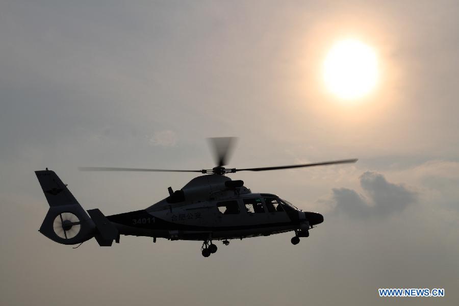 A police helicopter cruises in Hefei, capital of east China's Anhui Province, July 18, 2012. The helicopter with functions for police guard and fire fighting started its official cruise in Hefei on Wednesday. (Xinhua/Zhang Duan) 