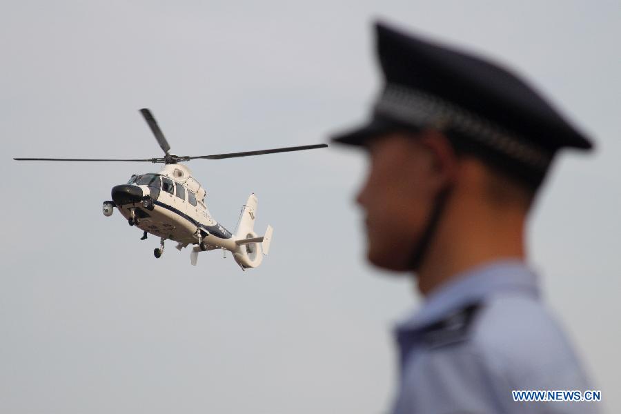 A police helicopter flies in Hefei, capital of east China's Anhui Province, July 18, 2012. The helicopter with functions for police guard and fire fighting started its official cruise in Hefei on Wednesday. (Xinhua/Zhang Duan) 