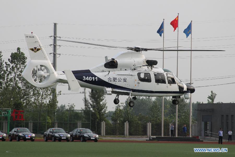 A police helicopter cruises in Hefei, capital of east China's Anhui Province, July 18, 2012. The helicopter with functions for police guard and fire fighting started its official cruise in Hefei on Wednesday. (Xinhua/Zhang Duan) 