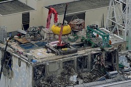 The crane at work atop reactor No.4. [Agencies] 