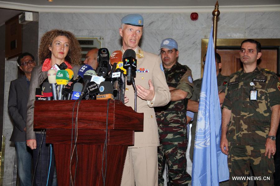 Major-General Robert Mood (C), head of United Nations Supervision Mission in Syria (UNSMIS), speaks during a press conference in Damascus, Syria, on July 19, 2012.