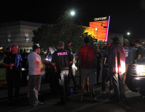 Police cordon off an scene at a movie theater where a shooting killed 14 people wounded 50 others during a showing of new Batman film 'The Dark Knight Rises' in Denver in the early hours of Friday. [Photo/Xinhua]