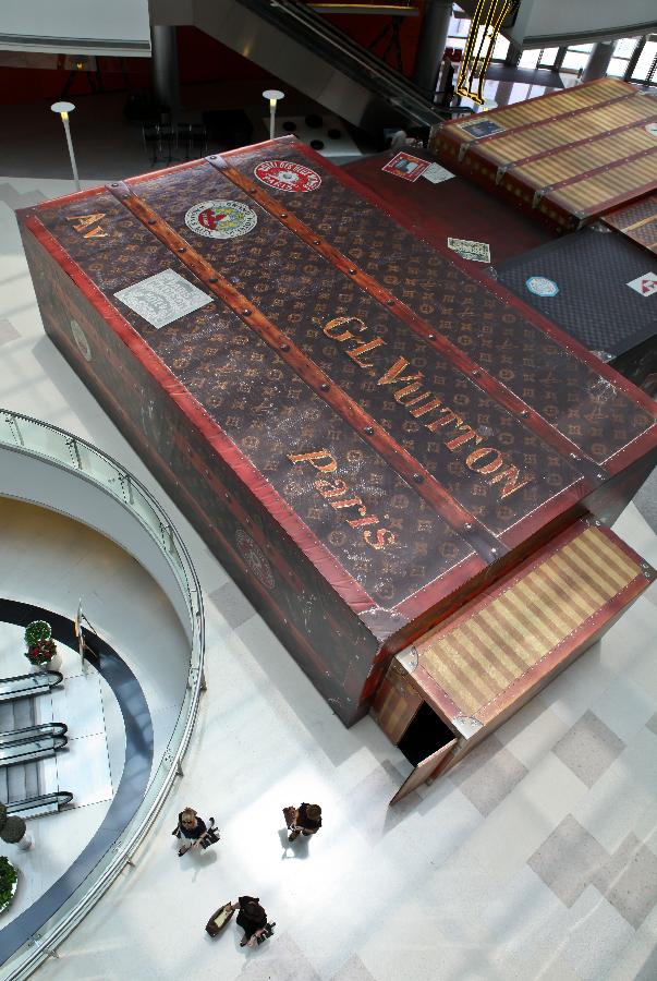 Photo taken on July 20, 2012 shows a large Louis Vuitton suitcase at the Louis Vuitton Maison at the Hang Lung Plaza in Shanghai, east China. The French luxury brand Louis Vuitton is set to open its largest China store in Shanghai on Saturday. It is also the first Louis Vuitton Maison in the Chinese mainland. [Xinhua]