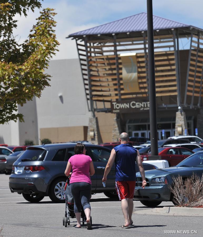 Customers make their way to Town Center, where the shooting rampage happened in Aurora, Colorado, July 22, 2012. Twelve people were killed and 59 others injured at a Batman movie premier, where a lone, heavily armed gunman burst into a packed theater in a suburb 10 miles east of Denver during the wee hours of Friday. (Xinhua/Yang Lei) 