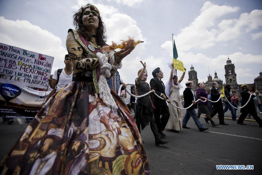 A woman wears a costume as she takes part in a demonstration protesting against the outcome of the July 1 general elections, in Mexico City, capital of Mexico, on July 22, 2012. Protesters marched to the Zocalo in downtown Mexico City. Thousands of demonstrators marched through Mexico City on Sunday to protest the outcome of the July 1 general elections, which declared Institutional Revolutionary Party (PRI) presidential candidate Enrique Pena Nieto the winner. (Xinhua/Rodrigo Oropeza) 