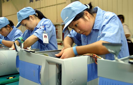 Lenovo Group Ltd's workers assembling PCs in the company's manufacturing center in Shanghai.
