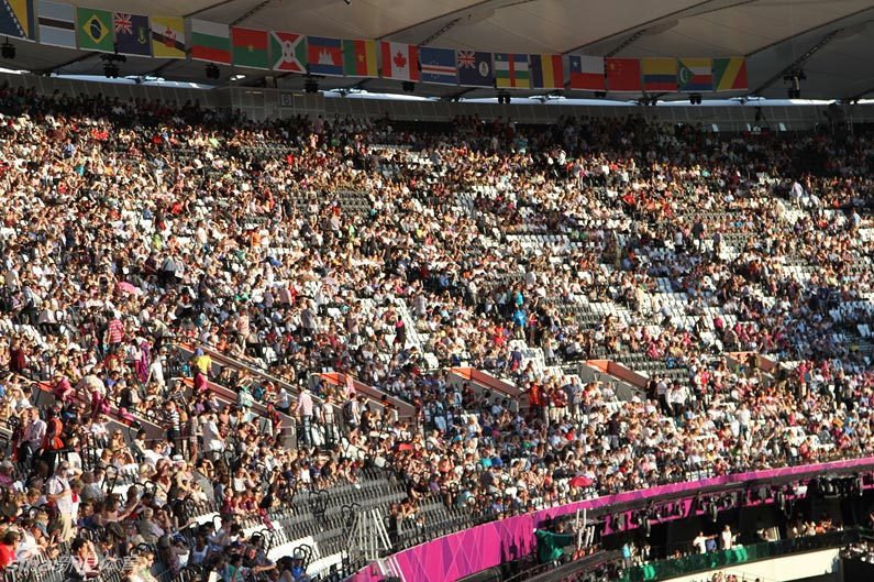  Large crowd of audience watch the rehearsal for the London Olympics opening ceremony.