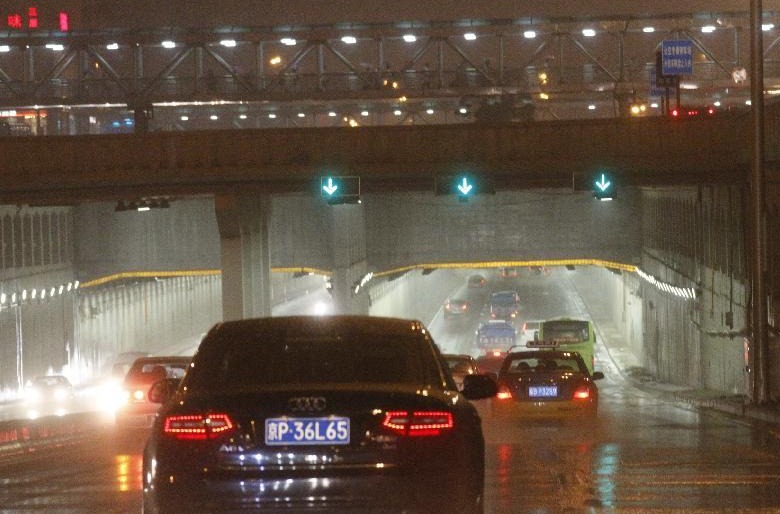 Vehicles move under an underpass near the Beijing West Railway Station in Beijing, capital of China, July 27, 2012. A new round of torrential rain pelted the capital Friday evening.