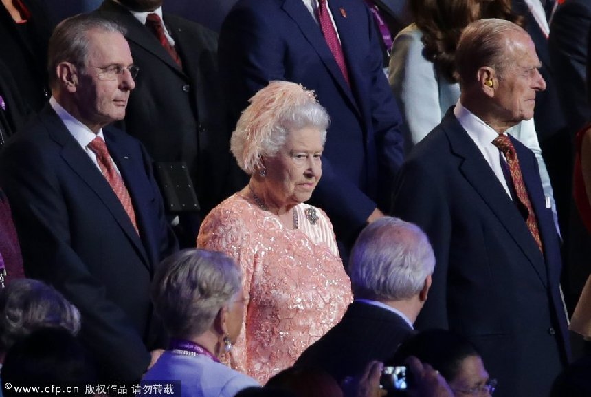 Britain's Queen Elizabeth II (C) and her husband Prince Philip (R), Duke of Edinburgh and the President of the International Olympic Committee Count Jacques Rogge (L) seen on the stands during the Opening Ceremony of the London 2012 Olympic Games, London, Britain, 27 July 2012. The 2012 Summer Olympic Games will be held in London from 27 July to 12 August 2012. [CFP]