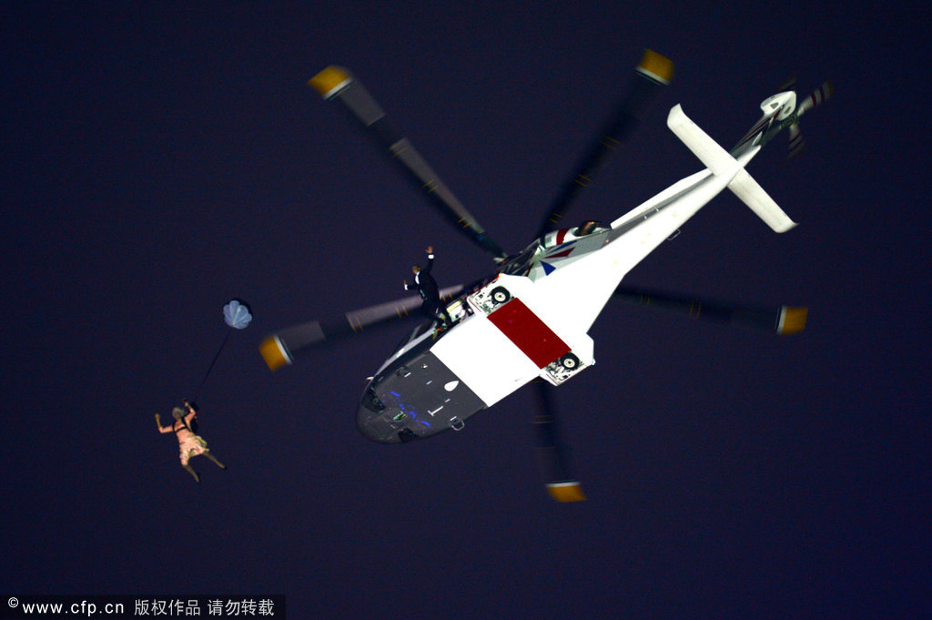 Gary Connery and Mark Sutton parachute into the stadium as part of short James Bond film featuring Daniel Craig and The Queen during the Opening Ceremony of the London 2012 Olympic Games at the Olympic Stadium on July 27, 2012 in London, England. [CFP]