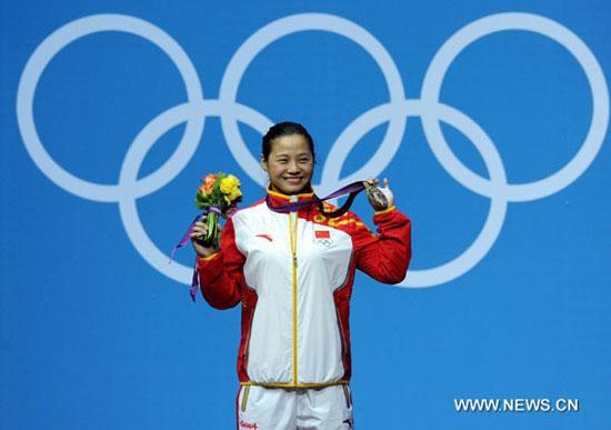 Gold Medalist Li Xueying of China poses for pictures during the victory ceremony of women's weightlifting 58kg competition, at London 2012 Olympic Games in London, Britain, on July 30, 2012. Li Xueying of China won gold medal with a new Olympic record of 246kg. [Xinhua]