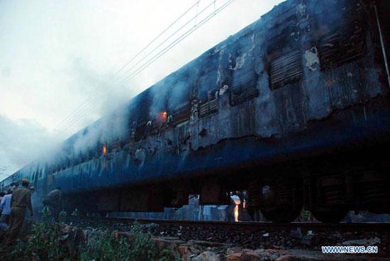 Firefighters try to extinguish the fire of a burning coach of a passenger train at Nellor nearly 500 kilometers from Hyderabad, India, July 30, 2012. At least 47 people have been charred to death and 25 others sustained burn injuries in a major fire that broke out in one of the coaches of an express train in the southern Indian state of Andhra Pradesh in the early hours of Monday, a senior police official said. [Xinhua] 