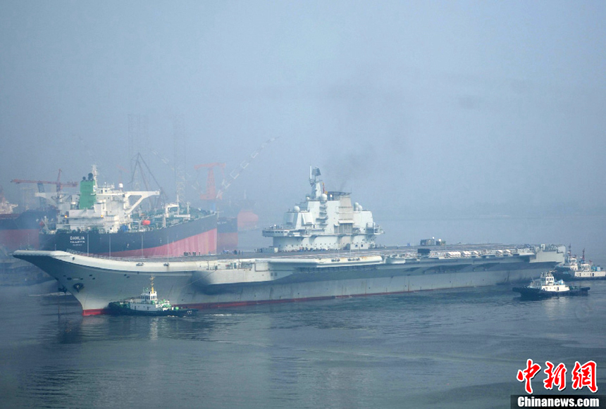 China's aircraft carrier platform returns to the dock in Dalian, northeast China's Liaoning Province, after finishing its 9th sea trial,July 30, 2012. The trial lasted 25 days, the longest one in its history. 