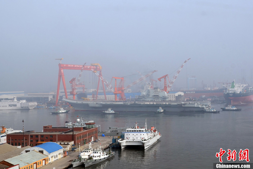 China's aircraft carrier platform returns to the dock in Dalian, northeast China’s Liaoning Province, after finishing its 9th sea trial,July 30, 2012. The trial lasted 25 days, the longest one in its history. 